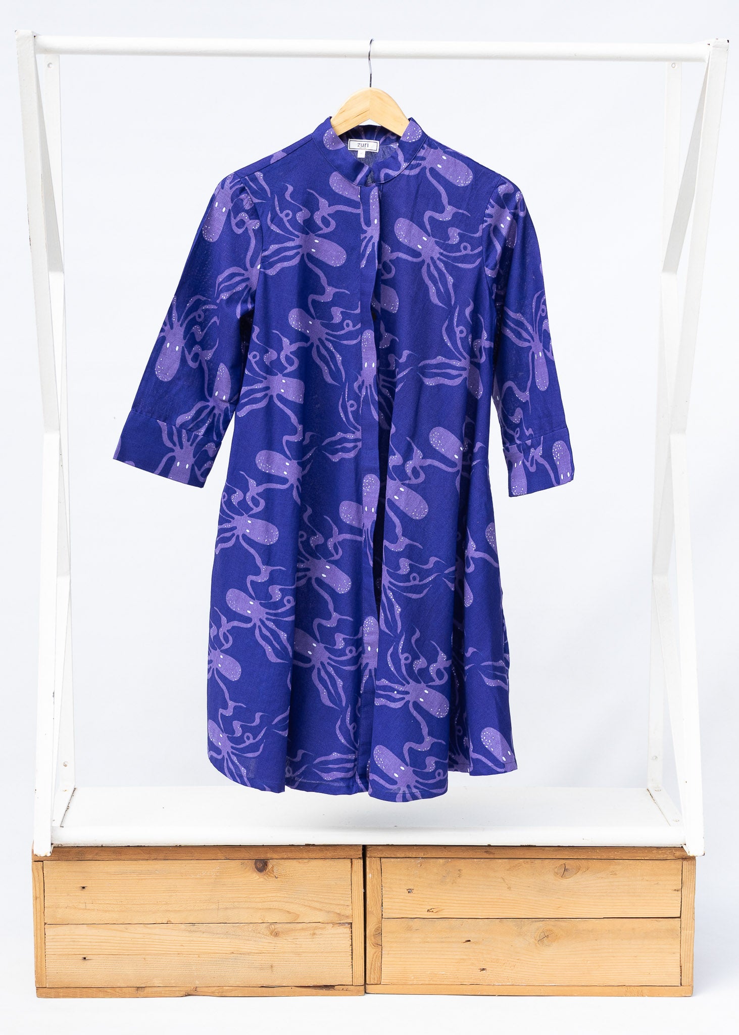 Display of purple dress with octopus print.