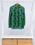 Display of green and blue snail print, long sleeved shirt.