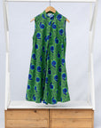Display of sleeveless dress with green and blue snail print.