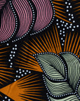 Close up display of orange and pink long sleeved blouse.