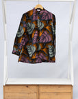 Display of orange and pink long sleeved blouse.