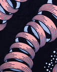Close up display of black and pink sleeveless print dress.