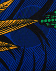 Close up display of blue sleeveless dress with orange and green print.