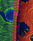 Close up display of green, orange and pink multiprint shirt.