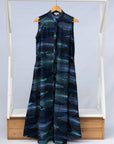 Display of black dress with aqua and navy abstract print.