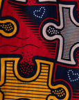 Close up display of multicolored puzzle print shirt, fabric.