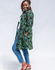 Model wearing green camo print like dress.