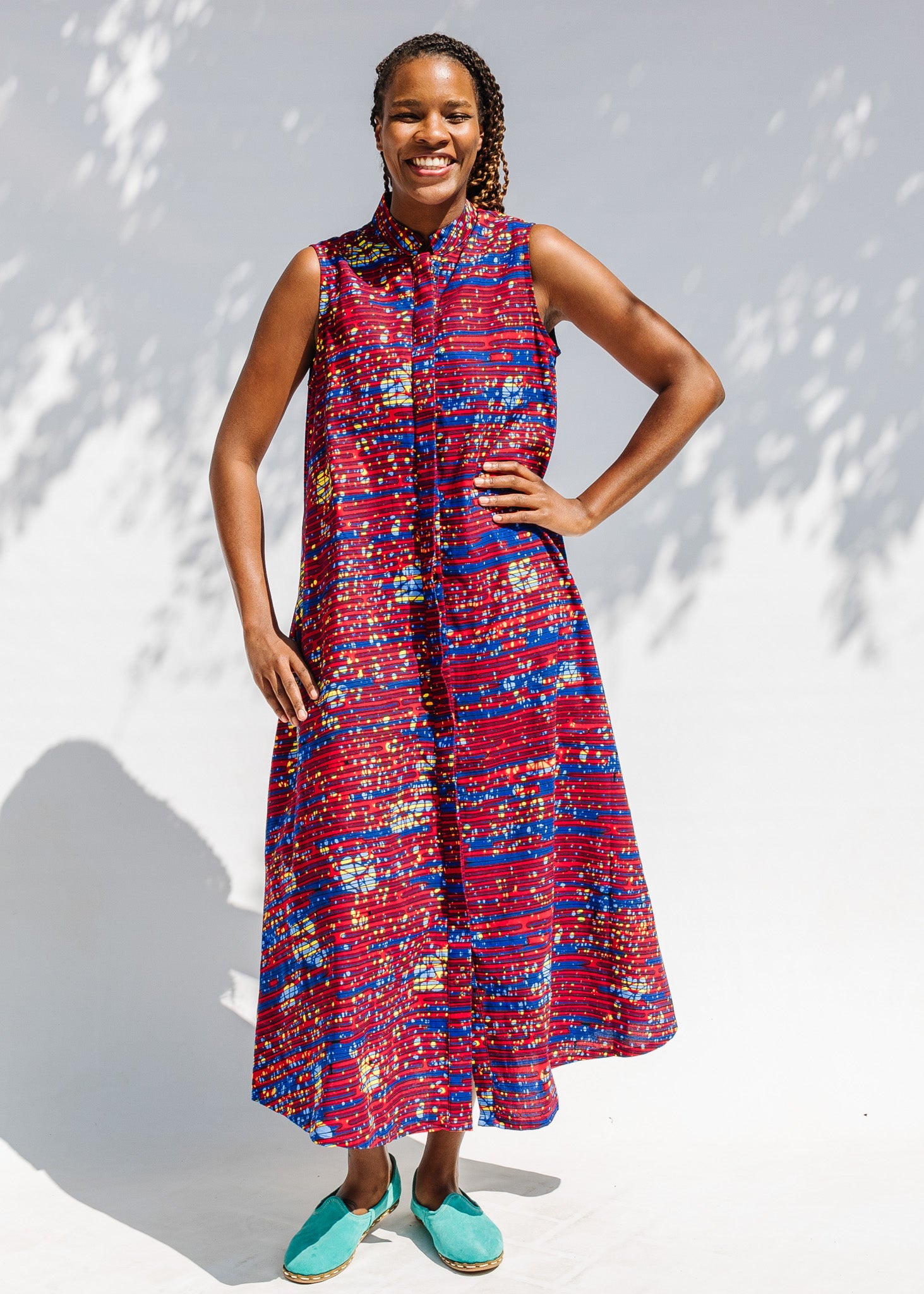 Model wearing a red and blue graphic print sleeveless dress.