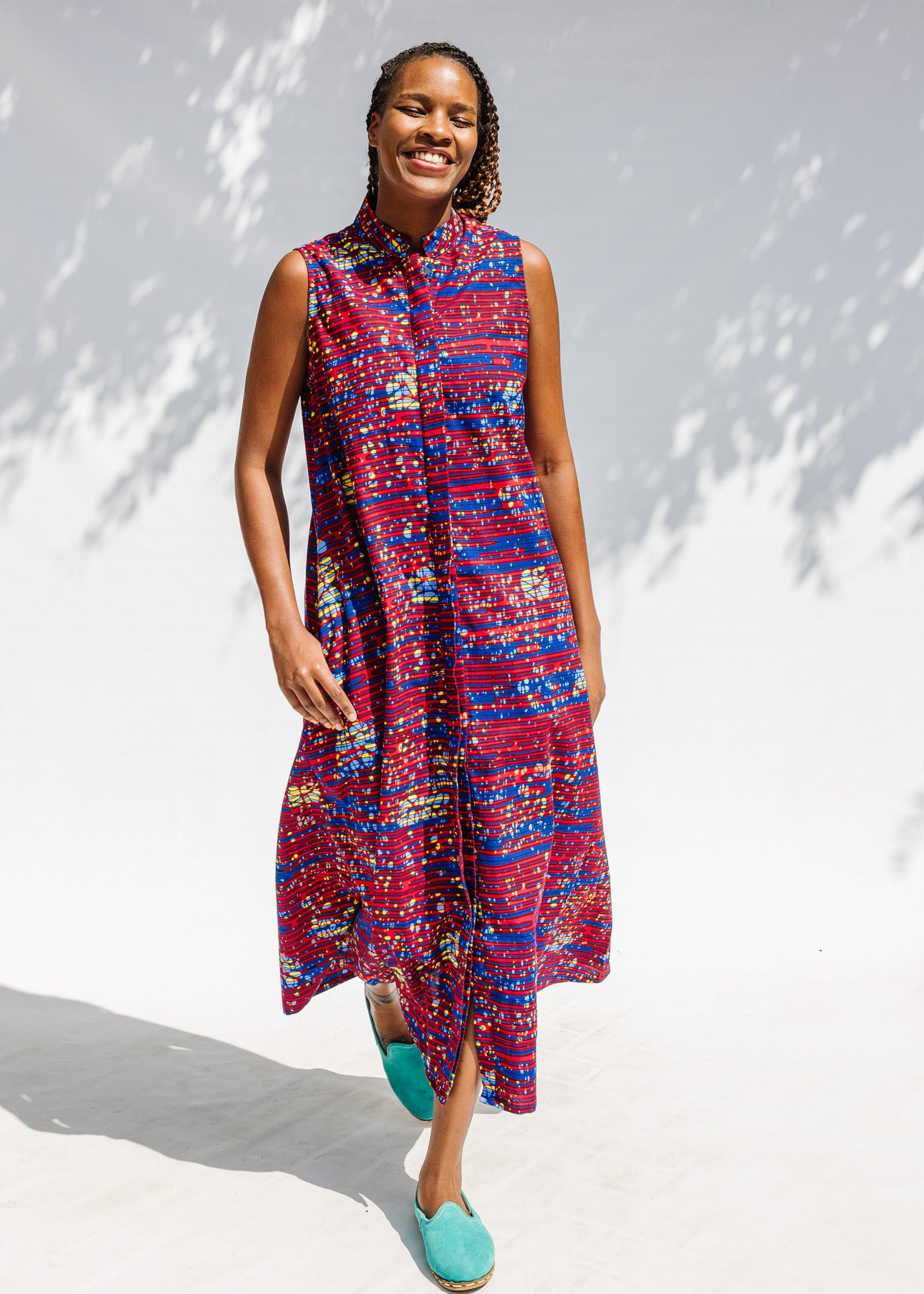 Model wearing a red and blue graphic print sleeveless dress.
