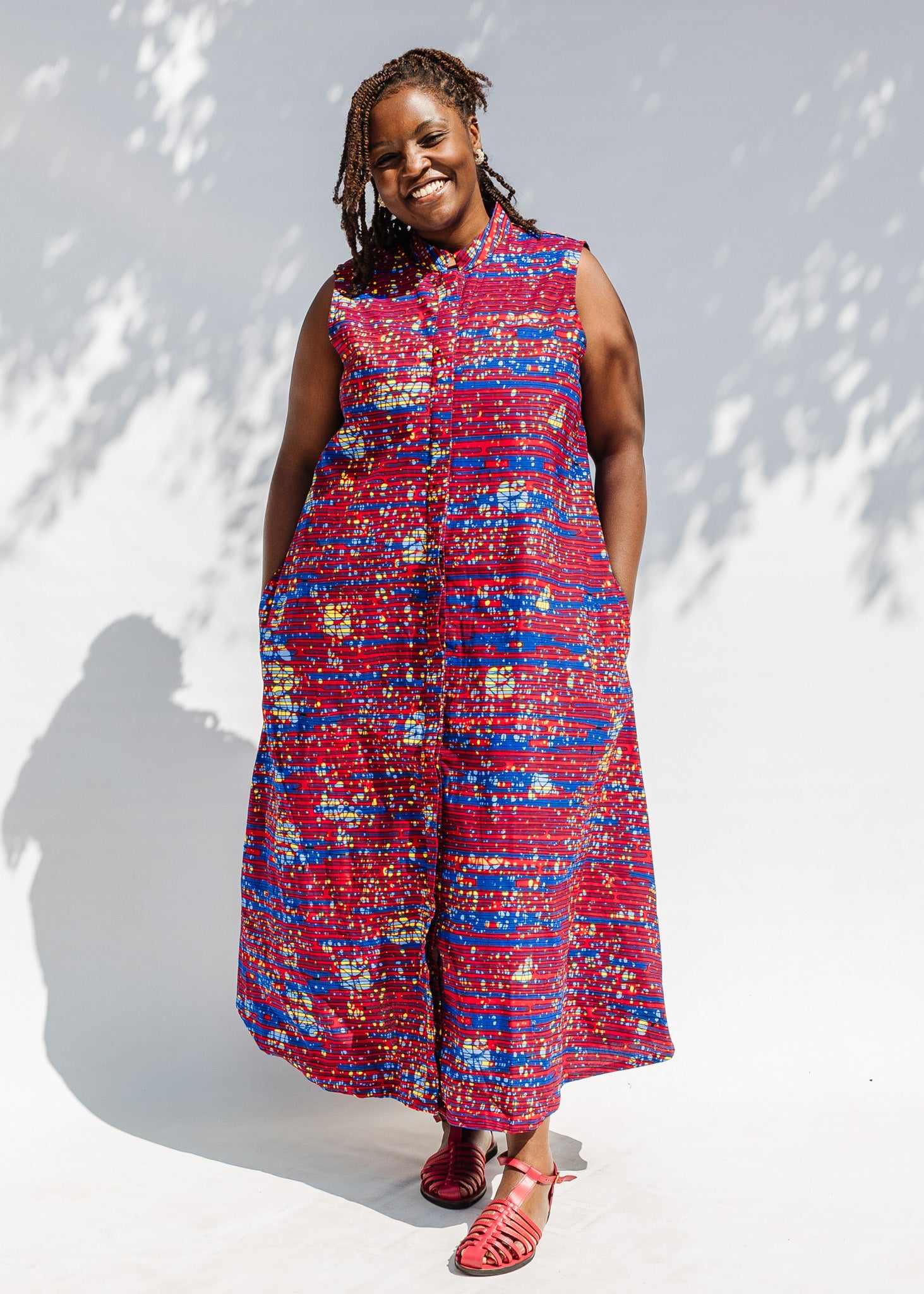 Model wearing a red and blue graphic print sleeveless dress.