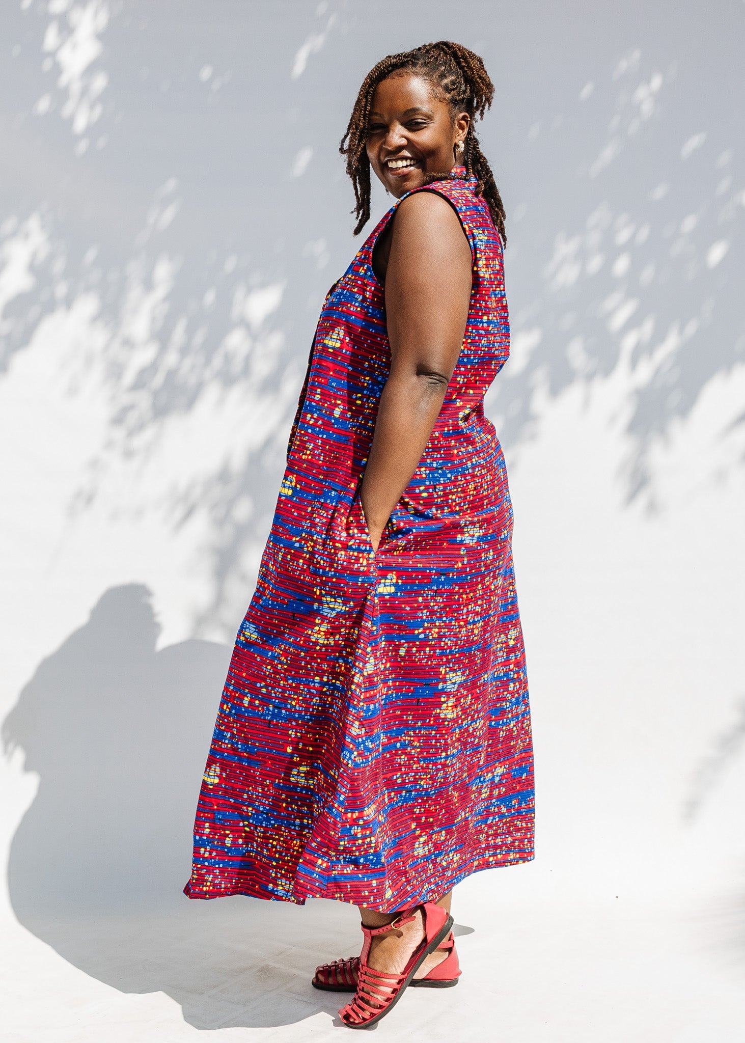 Model wearing a red and blue graphic print sleeveless dress.