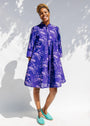 Model wearing purple dress with octopus print.