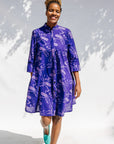 Model wearing purple dress with octopus print.