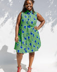 Model wearing sleeveless dress with green and blue snail print.