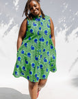 Model wearing sleeveless dress with green and blue snail print.