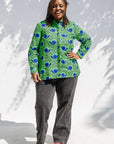 Model wearing green and blue snail print, long sleeved shirt.