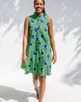 Model wearing sleeveless dress with green and blue snail print.