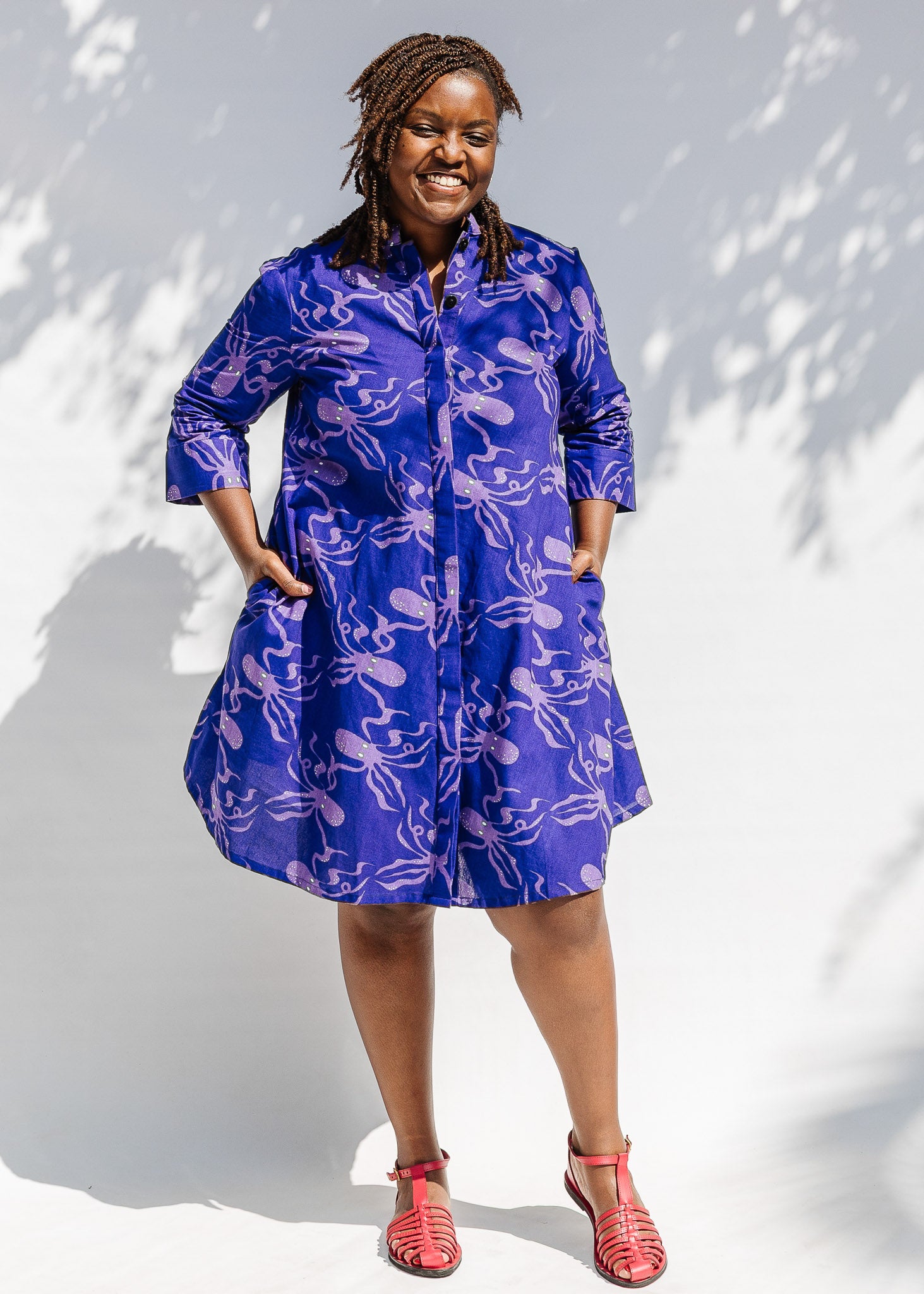 Model wearing purple dress with octopus print.