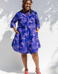 Model wearing purple dress with octopus print.