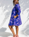 Model wearing purple dress with octopus print.