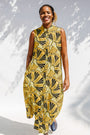 Model wearing yellow and black sleeveless maxi dress.