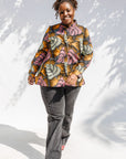 Model wearing pink and orange long sleeved blouse.