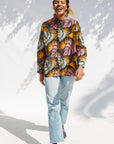 Model wearing pink and orange long sleeved blouse.