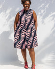 Model wearing black and pink sleeveless print dress.