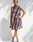Model wearing black and pink sleeveless print dress.