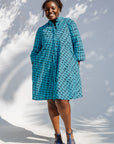 Model wearing blue and black squiggle print dress.