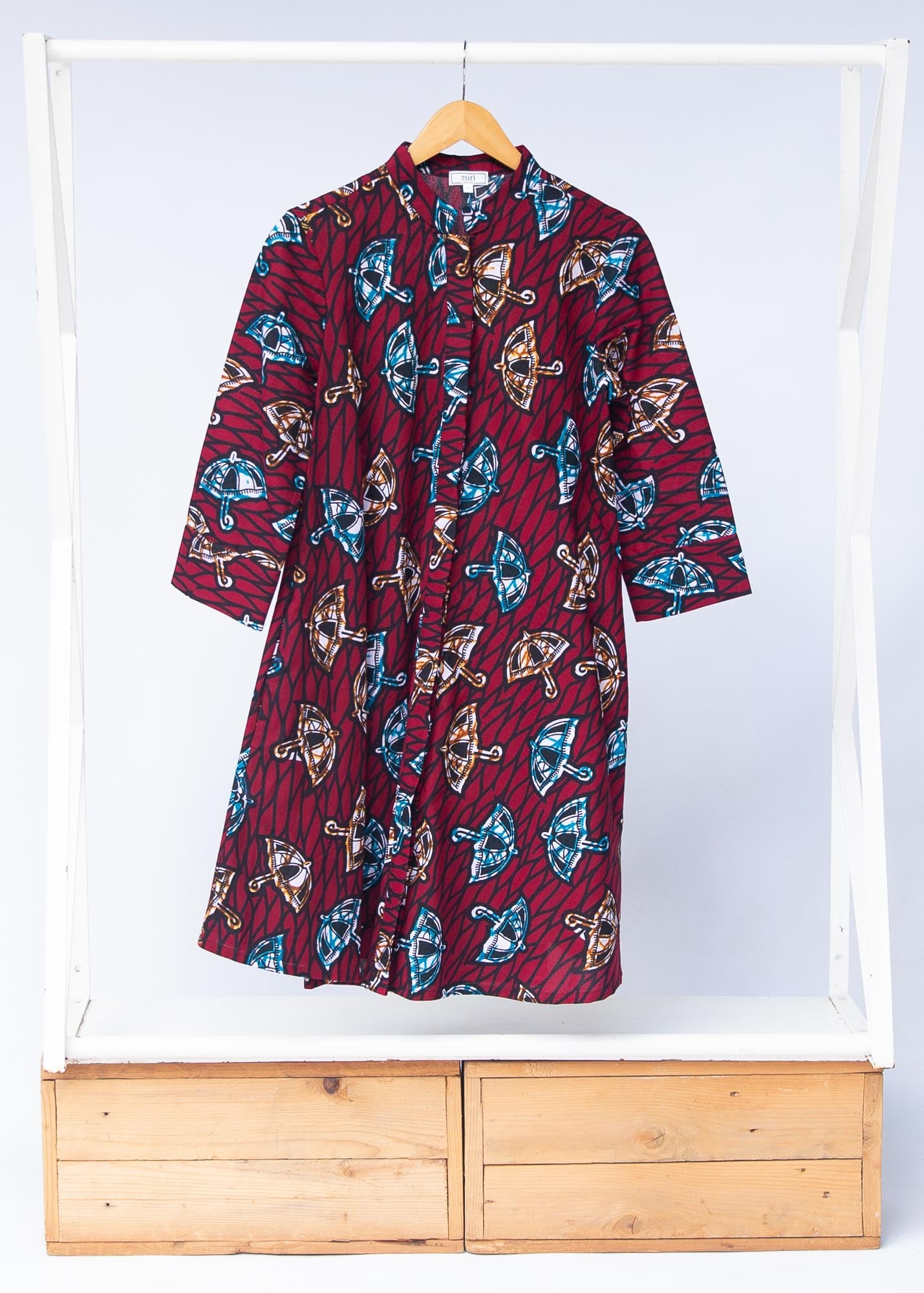 Display of red and black dress with umbrella design print