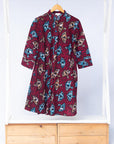 Display of red and black dress with umbrella design print