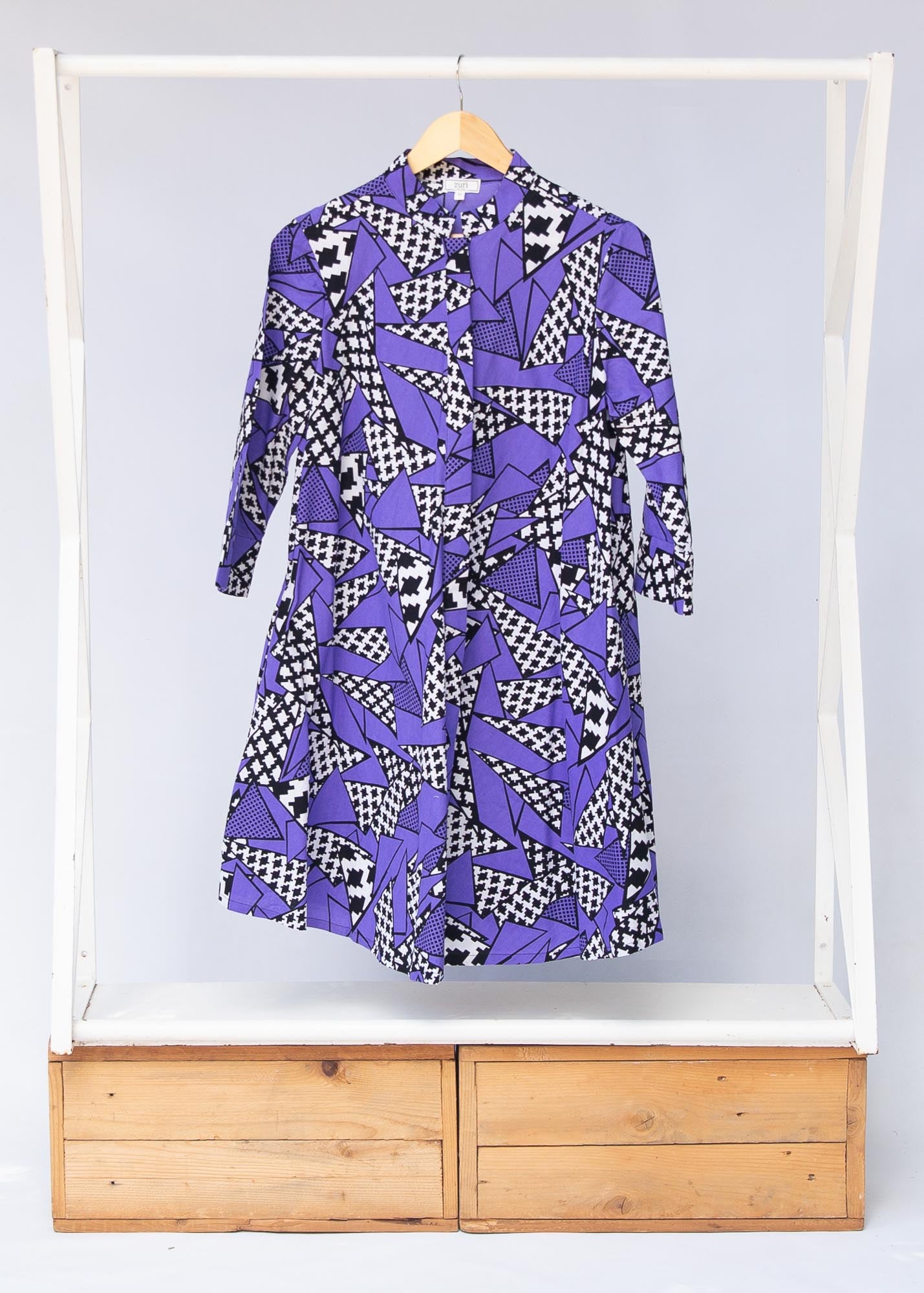 Display of purple, black and white geometric print dress