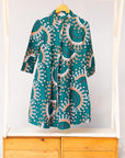 Display of teal, white, black and peach dress with gears