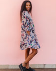 The model is wearing multi-colored floral print