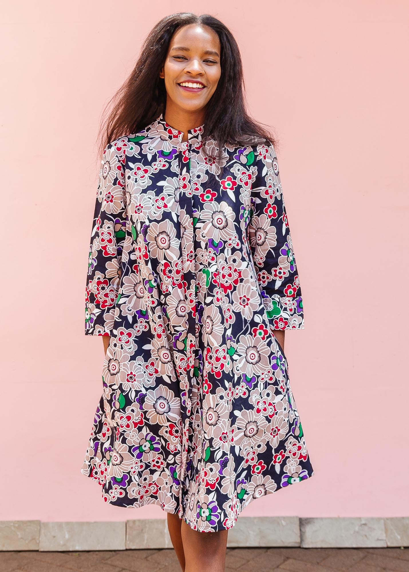 The model is wearing multi-colored floral print