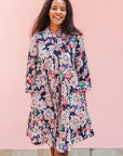 The model is wearing multi-colored floral print
