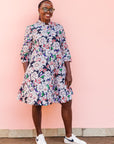 The model is wearing multi-colored floral print