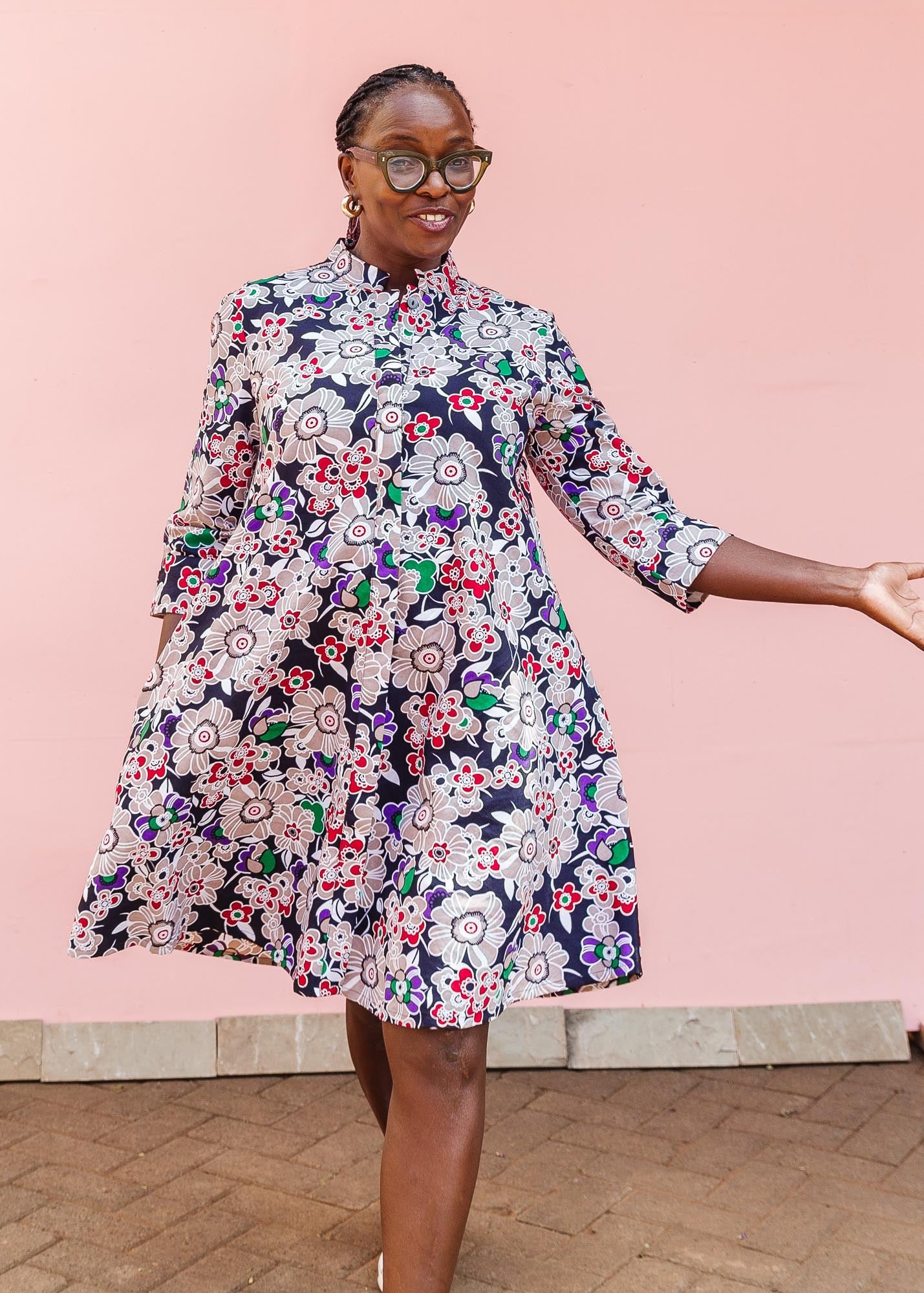 The model is wearing multi-colored floral print