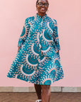 The model is wearing teal, white, black and peach dress with gears