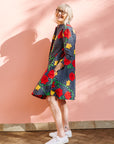Model wearing gray and black dress with yellow and red rose print.