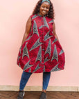 The model is wearing red and black dress with navy blue and beige print