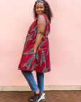 The model is wearing red and black dress with navy blue and beige print