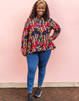 The model is wearing navy shirt with red, orange, yellow and white geometric print