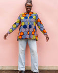 The model is wearing multicolored long sleeved shirt with geometric print