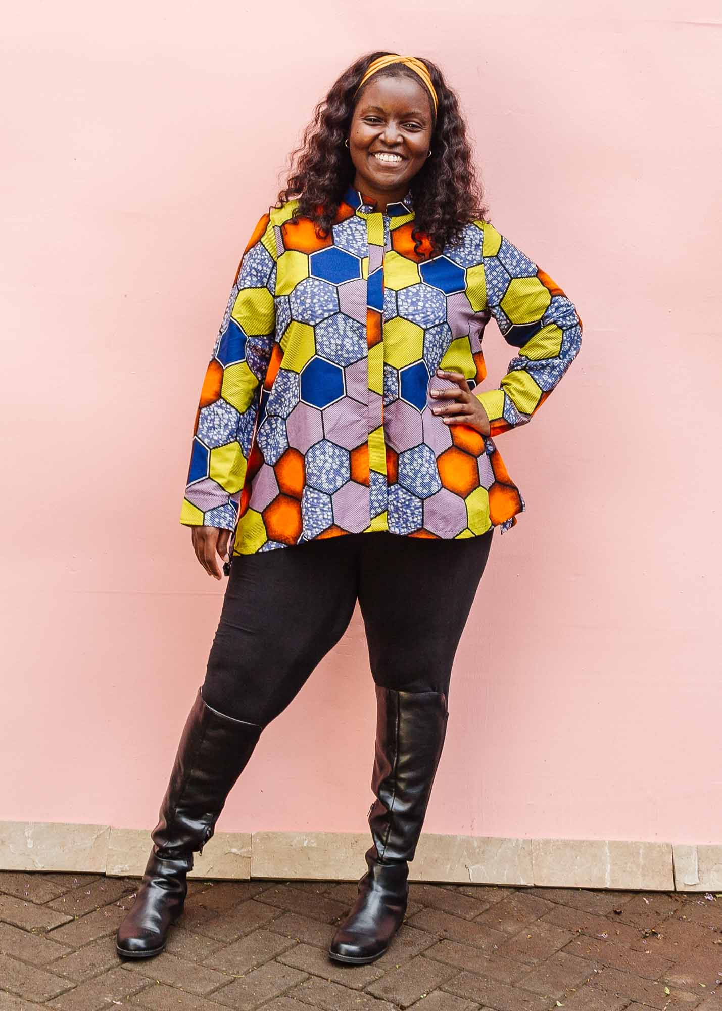 The model is wearing multicolored long sleeved shirt with geometric print