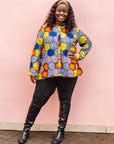 The model is wearing multicolored long sleeved shirt with geometric print