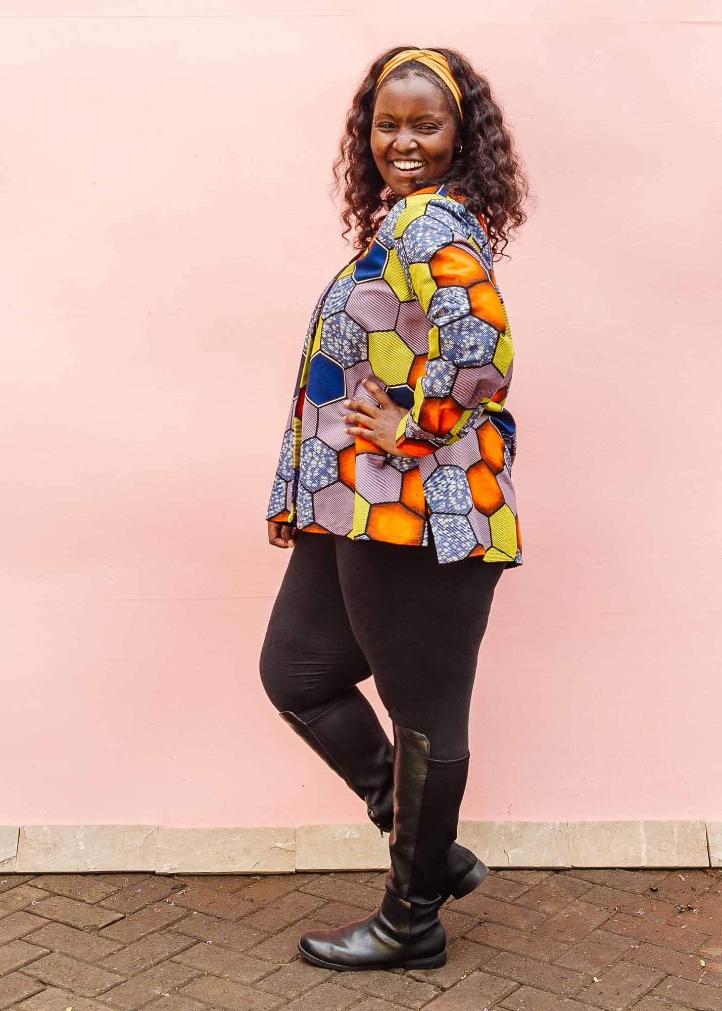 The model is wearing multicolored long sleeved shirt with geometric print