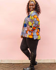 The model is wearing multicolored long sleeved shirt with geometric print