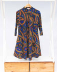 The display blue, red, black, yellow and white ornamental print dress